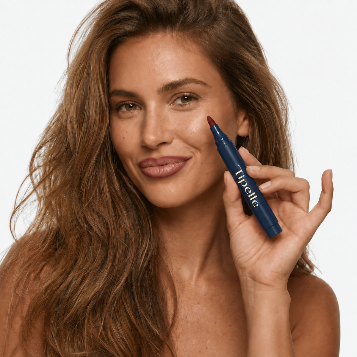 Tipelle lip pen held beside the face