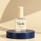 Tipelle Top Coat bottle on a navy plinth
